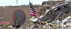 U.S. flag stands near destroyed car outside Oklahoma elementary school destroyed in massive tornado