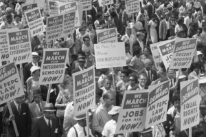 Demonstrators holding signs march during the 1963 March on Washington. As the 50th anniversaries of key civil rights events approach, some observe that there's still a long way to go toward eliminating racism in U.S. society. (CNS photo/Library of Congress)