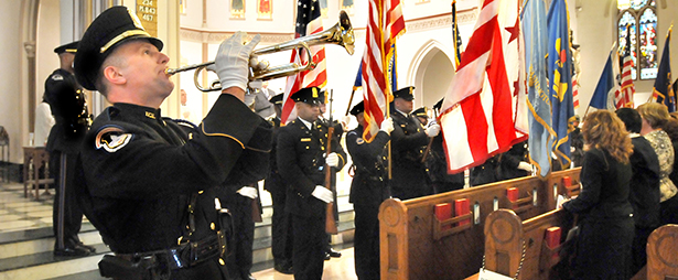 OFFICER PLAYS TRUMPET DURING ANNUAL BLUE MASS AT WASHINGTON CHURCH