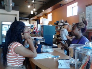 Ivy Bell, right, one of the worker/owners at Community Blend, assists customers.