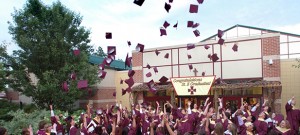 Graduates throw their caps into the air after commencement ceremonies. (CNS photo/Don Blake, The Dialog) 