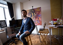 Essa Neima poses for a photo in his art studio in Washington.  The Syrian artist said he got the idea to showcase his countryÕs struggles after extremists killed a Jesuit priest friend there. (CNS photo/Tyler Orsburn) 