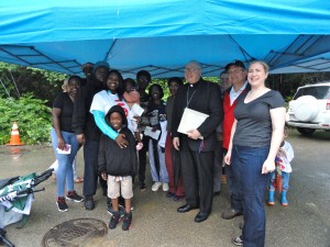 Future homeowner Ebony Bureau, her children, family members and friends, pose for a picture with Habitat for Humanity representatives and Auxiliary Bishop Joseph R. Binzer after the construction kick-off for the Pope Francis House.  CT Photo/Eileen Connelly OSU