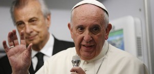 Pope Francis answers questions from journalists aboard his flight from Asuncion, Paraguay, to Rome July 12. (CNS photo/Paul Haring) 