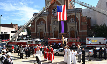 Father Steve Angi blessed emergency vehicles at the 2014 Blue Mass at the Cathedral of St. Peter in Chains. (CT Photo/John Stegeman)