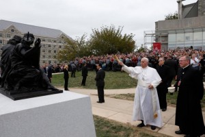 Pope Francis blesses a sculpture during a brief stop at St. Joseph's University in Philadelphia Sept. 27. The sculpture commemorates the 50th anniversary of "Nostra Aetate," the Second Vatican Council Declaration on the Relationship of the Church to Non-Christian Religions.  (CNS photo/Paul Haring)