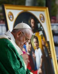 An image of the Holy Family is seen as Pope Francis celebrates the closing Mass of the World Meeting of Families on Benjamin Franklin Parkway in Philadelphia Sept. 27. (CNS photo/Paul Haring)