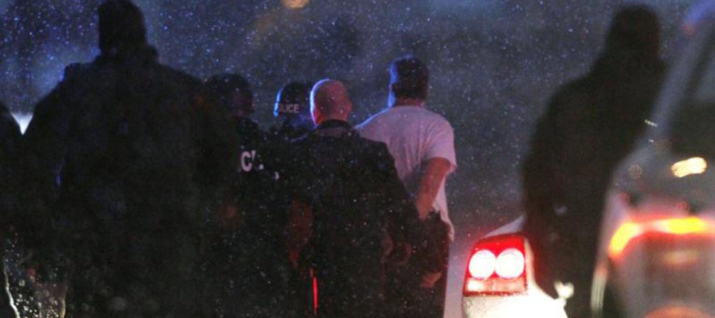 A suspect is taken into custody Nov. 27 outside a Planned Parenthood clinic in Colorado Springs, Colo. Police say Robert Lewis Dear killed three people during the shooting rampage and hours-long standoff at the clinic and was later taken into custody. (CNS photo/Rick Wilking, Reuters)