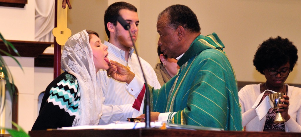 Bishop Edward Braxton of Belleville, Illinois distributes Holy Communion to Megan Earley Nov. 8 at the University of Dayton's Immaculate Conception Chapel. (CT Photo/Jeff Unroe)