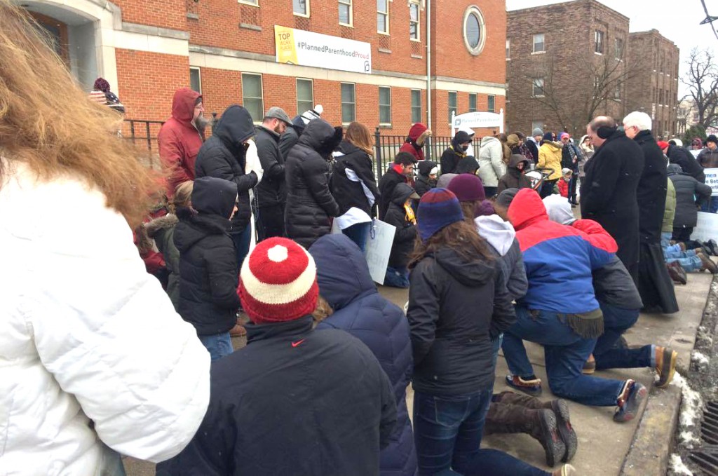 Pro-life supports kneel in prayer outside the Planned Parenthood location in Cincinnati on Jan. 22, 2016. (CT Photo/John Stegeman)