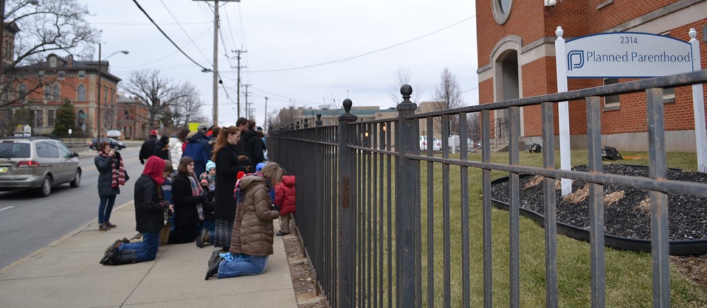 Pro-life supporters pray in front of the Planned Parenthood location in Cincinnati on Jan. 22, 2015 as part of the Greater Cincinnati Young Adults for Life Mini-March for Life. The Mini-March for life will take place again tomorrow from noon to 1 p.m. (CT Photo/John Stegeman)