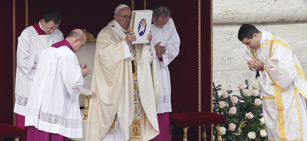 Pope Francis raises the Book of the Gospels as he celebrates the opening Mass of the Holy Year of Mercy in St. Peter's Square at the Vatican Dec. 8. (CNS photo/Paul Haring) 