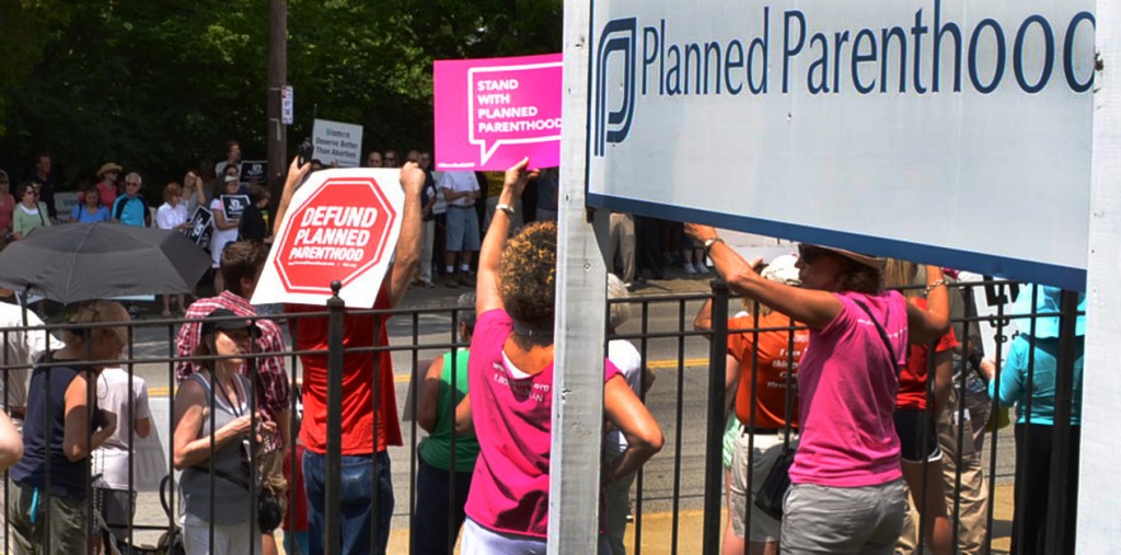 Pro-life and pro-life demonstrators hold signs during a July 29, 2015 #WomenBetrayed rally. (CT Photo/John Stegeman)