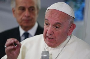 Pope Francis answers questions from journalists aboard his flight from Ciudad Juarez, Mexico, to Rome Feb. 17. (CNS photo/Paul Haring)