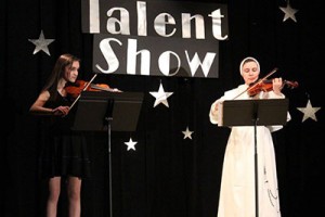 St. Gertrude eighth grader Olivia DeStefano and Junior High teacher Sister Veronica Marie, O.P. perform in a Catholic Schools Week Talent Show. 