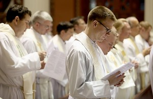 Father Ethan Moore, right, and other priests, sing during the Chrism Mass at the Cathedral of Saint Peter in Chains in Cincinnati Tuesday, March 22, 2016. (CT Photo/E.L. Hubbard)