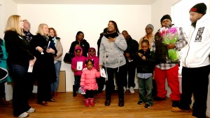 Ebony Bureau gives thanks during the Habitat for Humanity Pope Francis House Dedication Ceremony in Millvale Saturday, Jan. 23, 2016. Bureau, her children, Robert, 7, and Keiasa, 2, and her boyfriend, Robert Davis, III, will live in the house. (CT Photo/E.L. Hubbard)