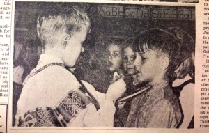 Steve Vogel, right, receives an unconsecrated host from "priest" Clark Monroe during a communion demonstration in preparation for the students' first communion in 1966. (CT File)