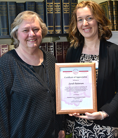 Archdiocese of Cincinnati Archivist Sarah Patterson, right, and volunteer Julie Ross were honored by the Hamilton County Genealogical Society for their work at the achieves. Each received a certificate though only Patterson's is seen here. (CT Photo/John Stegeman)