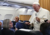 Pope Francis closes his eyes as he reacts to a question from Cindy Wooden, Catholic News Service Rome bureau chief, aboard his flight from Yerevan, Armenia, to Rome June 26. The pope reacted as Wooden mentioned the June 12 shooting that killed 49 at a nightclub in Orlando, Fla.