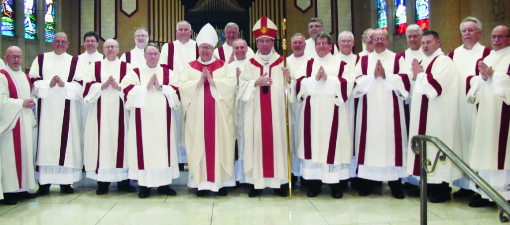 New permanent deacons of the Archdiocese of Cincinnati pose with Auxiliary Bishop Joseph Binzer, center left, and Archbishop M. Dennis Schnurr, center right, April 30 at our Lady of the Immaculate Conception Parish in Dayton.  (CT Photo/Jeff Unroe)