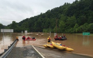 Emergency crews take out boats on a flooded I-79 June 24 after flooding in Kanawha, W.Va. The floods have killed at least 26 people, including a 4-year-old and an 8-year-old. As of June 27, almost 500,000 people were without power and 44 counties were under a state of emergency. (CNS photo/West Virginia Department of Transportation handout via Reuters) 