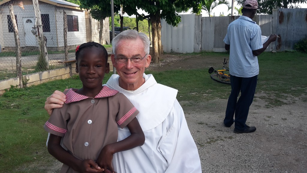 Franciscan Father Jim Bok poses with a Jamaican child. (Courtesy Photo)