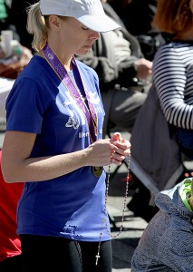 Kindal Farwick prays the Rosary during the 10th Annual Cincinnati Rosary Crusade on Fountain Square Saturday, October 8, 2016. (CT Photo/E.L. Hubbard)