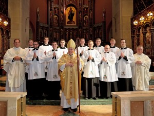 Photo Credit (l to r): Front Row: Bishop Joseph Binzer. Second Row: Father Anthony Brausch, Aaron Hess, John Stein, Edward Hoffmann, K. Scott Morgan, Louis Jacquemin, Father Benedict O'Cinnsealaigh. Back Row: Scott Brand, Elijah Puthoff, Michael Poussard, Kendall Ketterlin, Michael Kopolka, Anthony Marcelli. (Photo by E.L. Hubbard.)