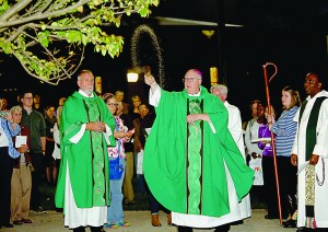 Bishop Joseph Binzer sprinkles Holy Water during a Tree Dedication Ceremony in Memory of Sister Dorothy Stang's Life & Legacy, outside the Bellarmine Chapel on Xavier University’s campus in Cincinnati Saturday, Oct. 29, 2016. (CT Photo/E.L. Hubbard)