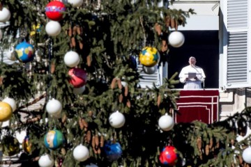 Pope Francis leads the Angelus from the window of his apartment overlooking St. Peter's Square Dec. 18 at the Vatican. (CNS photo/Claudio Peri, EPA)