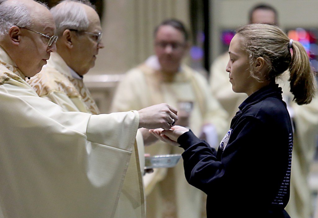 Auxiliary Bishop Most Reverend Joseph Binzer offers a student Communion during the Catholic Schools Week Mass at the Cathedral of Saint Peter in Chains in Cincinnati Tuesday, Jan. 31, 2017. (CT Photo/E.L. Hubbard)