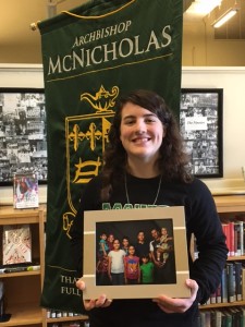 McNicholas senior Christiane Hazzard holds a photo of the Syrian family her parish, Immaculate Heart of Mary, has been assisting. (CT Photo/Sr. Eileen Connelly)