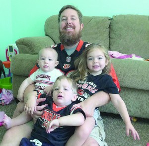 "I'm still a big sports fan" said Rod Dunlap, pictured in Bengals gear with his children. Dunlap is the head of Sports Ministry, a new focus for the Archdiocese. (Courtesy Photo)