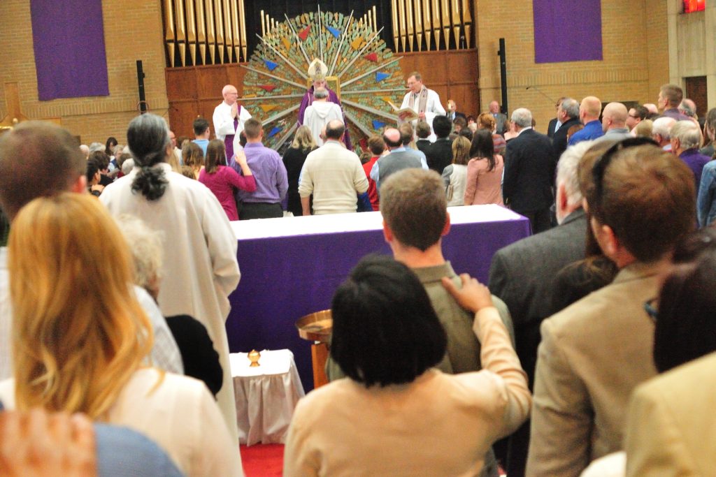 Elias Mwesigye leads the Recessional during the Rite of Election of Catechumens and of the Call to Continuing Conversion of Candidates who are preparing for Confirmation and Eucharist or Reception into Full Communion with the Roman Catholic Church at the Cathedral of St. Peter in Chains in Cincinnati Sunday, Mar. 5, 2017. (CT PHOTO/E.L. HUBBARD)