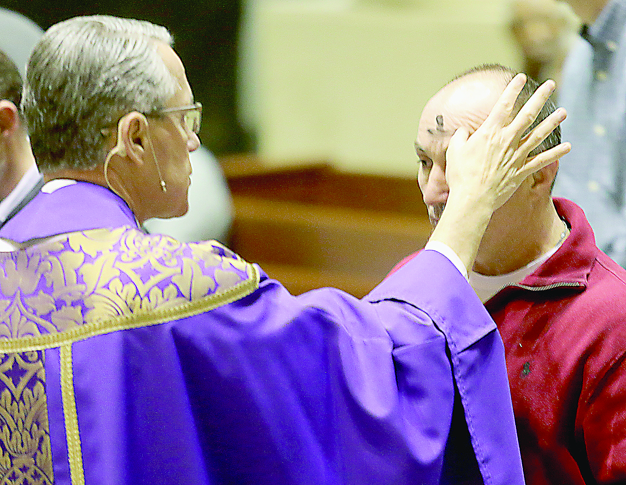 Rev. Raymond Larger marks a parishioner’s forehead with the sign of a cross during Ash Wednesday services at St. Peter in Chains Cathedral in Cincinnati Wednesday, Mar. 1, 2017. (CT PHOTO/E.L. HUBBARD)