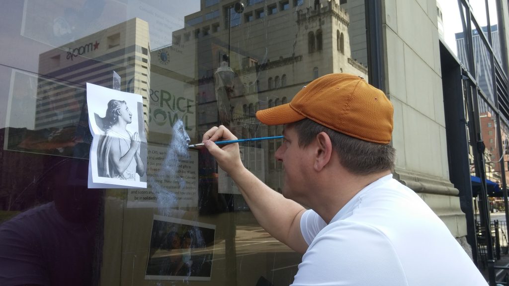 Michael Glass a St. Mary Greenville Ohio parishioner begins his painting at the display window.