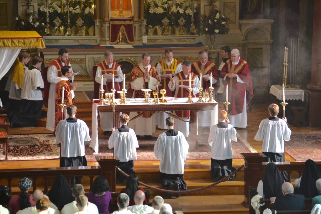 Oratory Father Mario Aviles (reading) with some of the concelebrating priests, Deacon Duy Nguyen, and servers. Left to right: Father John-Paul Bevak of Old St. Mary’s; Father Felix Selden, representing Rome; Archbishop Dennis Schnurr; Fathers Adrian Hilton and Lawrnce Juarez of Old St. Mary’s; and homilist  Msgr. Frank Lane. (CT Photo/Gail Finke)