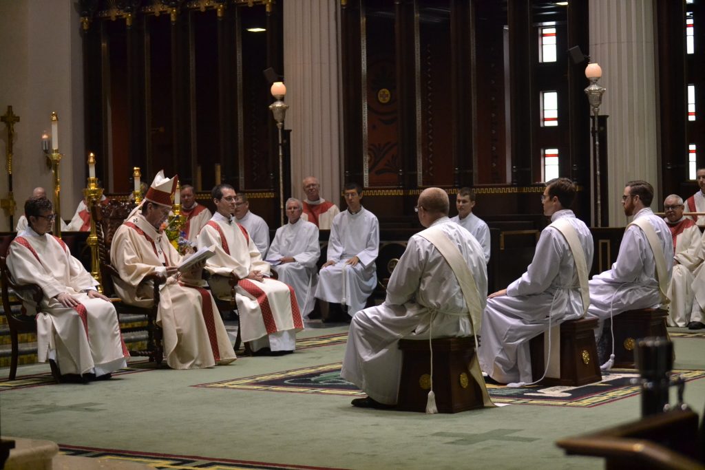 Archbishop Dennis M. Schnurr instructs David Doseck, Peter Langenkamp, Alexander Witt and the celebrating assembly (CT Photo/Greg Hartman)