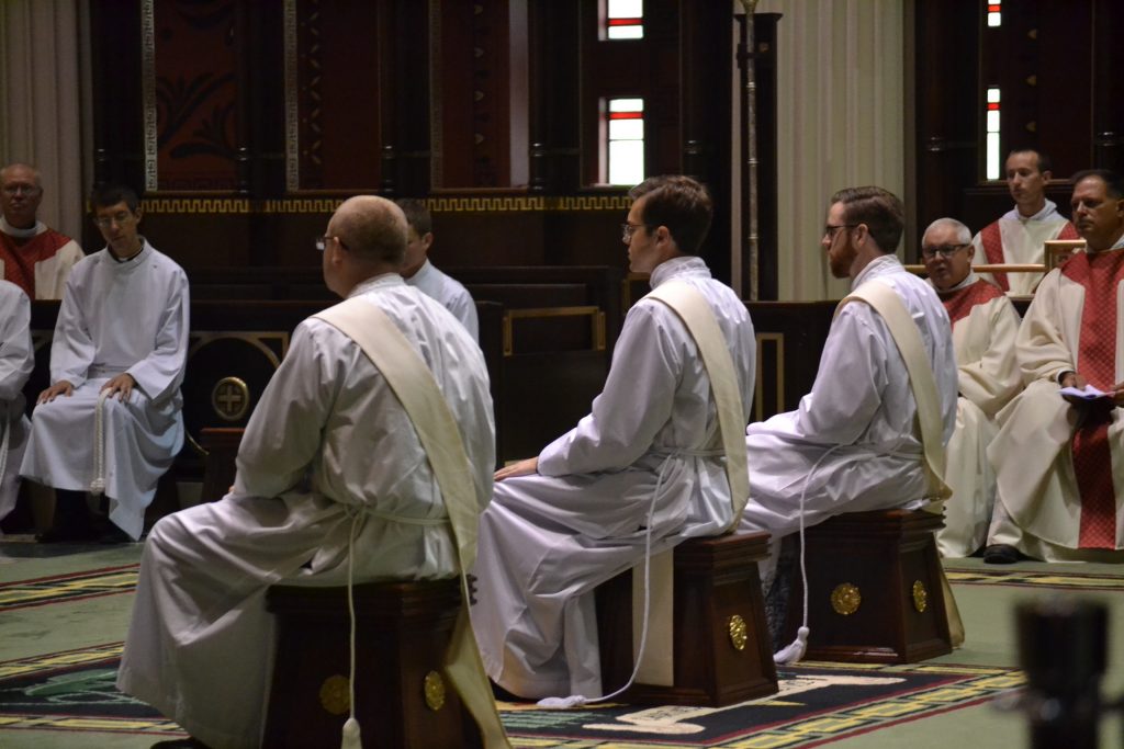 David Doseck, Peter Langenkamp, and Alexander Witt listen to Archbishop Schnurr's Homily (CT Photo/Greg Hartman)