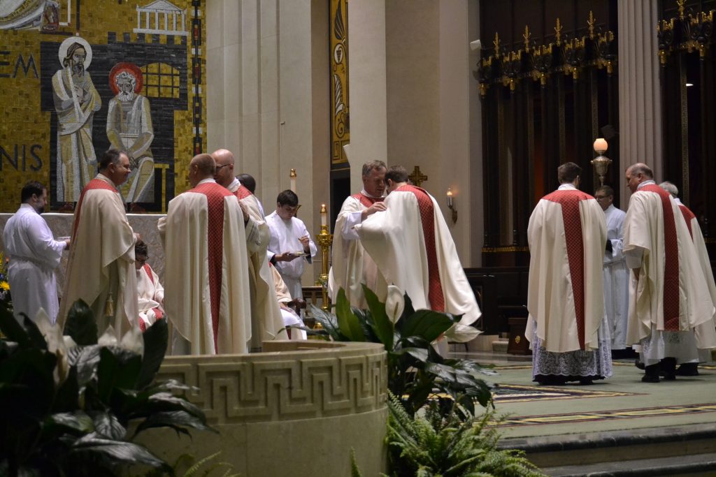 The newly ordained David Doseck, Peter Langenkamp, and Alexander Witt are vested with Eucharistic garments of their office, the stole and chasuble. (CT Photo/Greg Hartman)