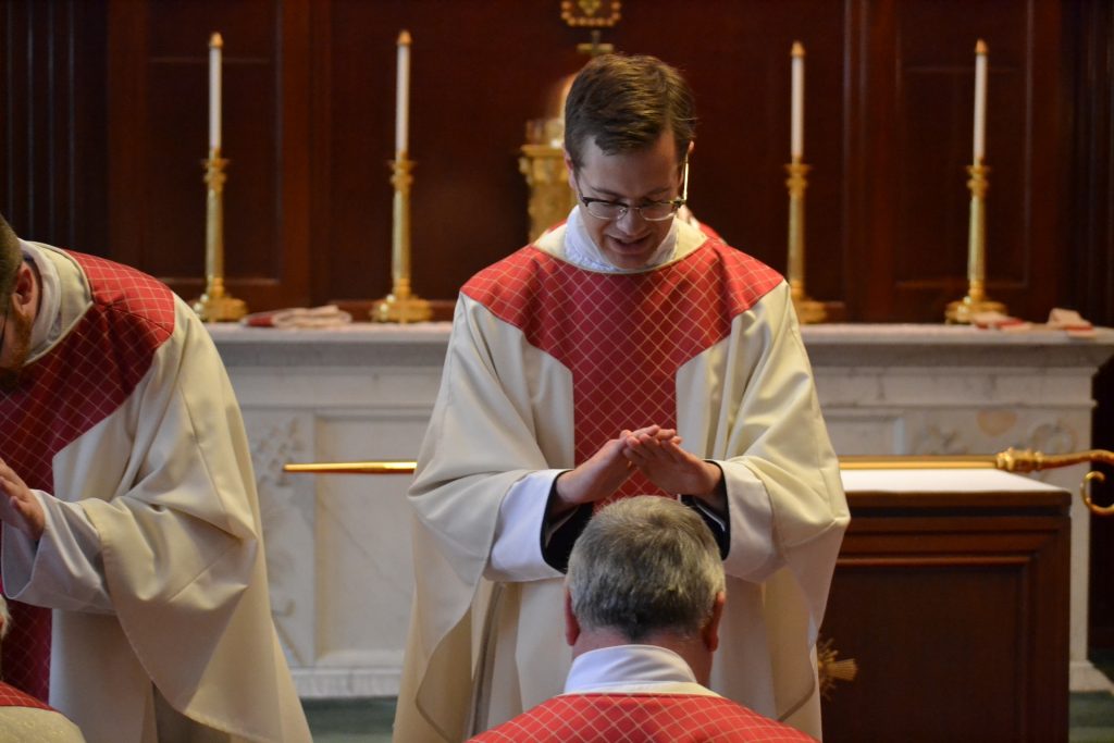 Reverend Peter Langenkamp laying of hands after Mass. (CT Photo/Greg Hartman)
