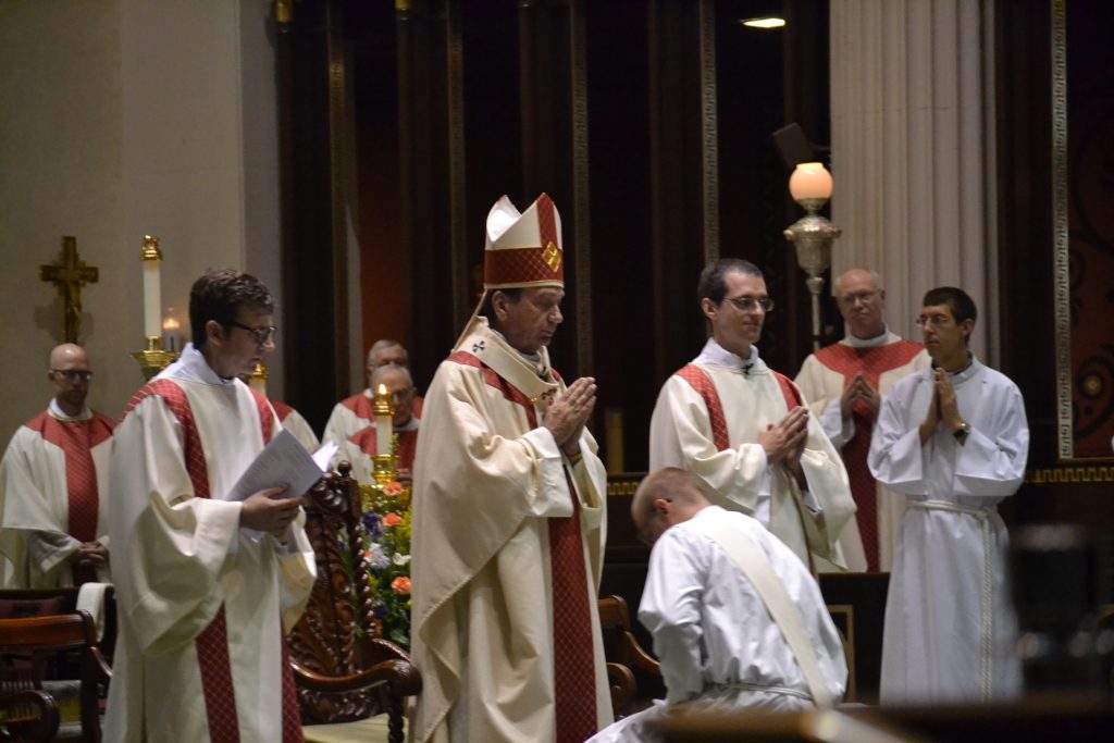 Archbishop Schnurr lays his hands on the head of David Doseck in silence in the Laying on of Hands (CT Photo/Greg Hartman)