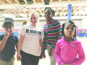 Kate Sampson poses with neighborhood children during a roller skating party in Over-the-Rhine.  (Courtesy Photo)