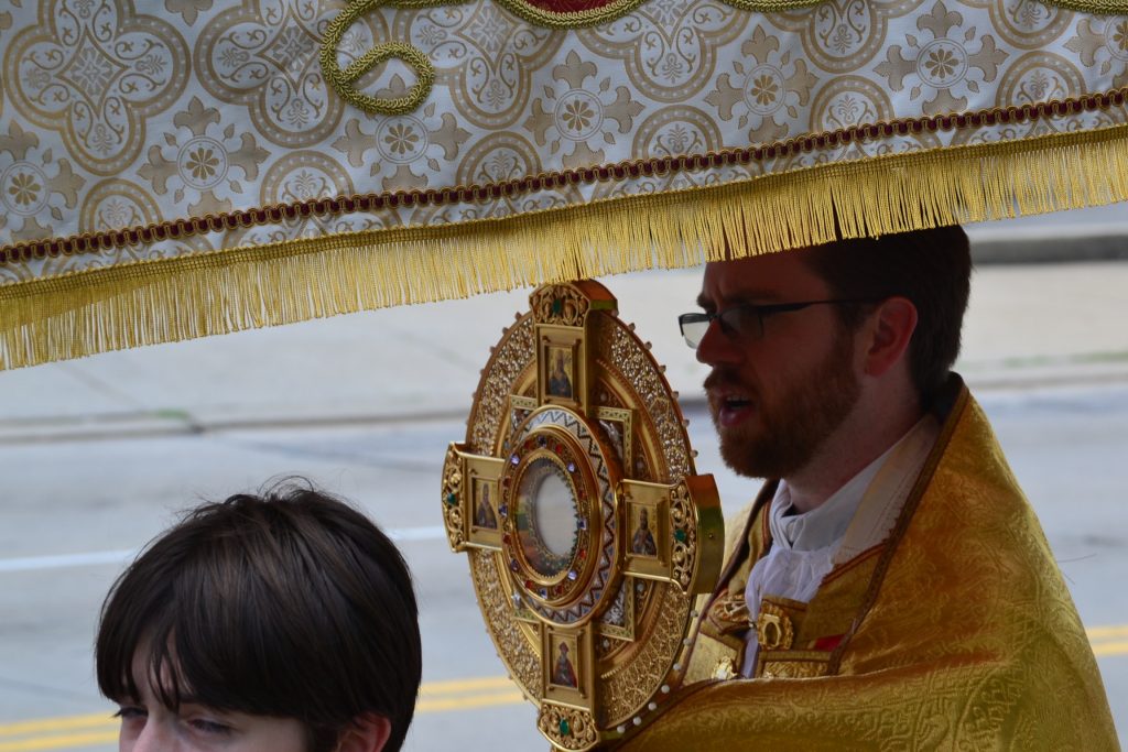 Fr. Alexander Witt carries the Monstrance during the procession. (CT Photo/Greg Hartman)