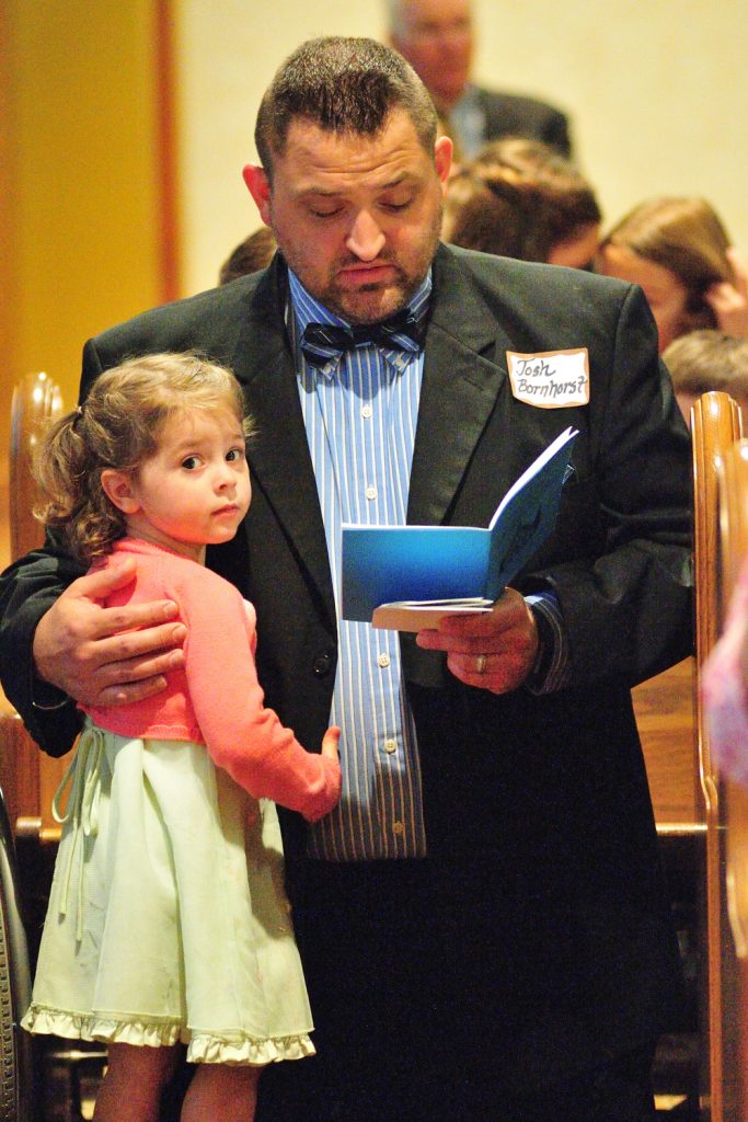 Josh Bornhorst and his 3 year old daughter Esther together during holy Mass (CT Photo/Jeff Unroe)