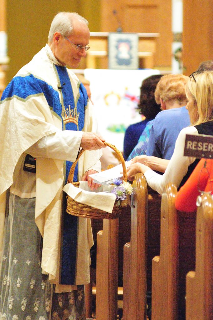 Rev. Stephen Mondiek, Schoenstatt Diocesan Priest collects new members of the Covenant of Schoenstatt letters they wrote to themselves. (CT Photo/Jeff Unroe)