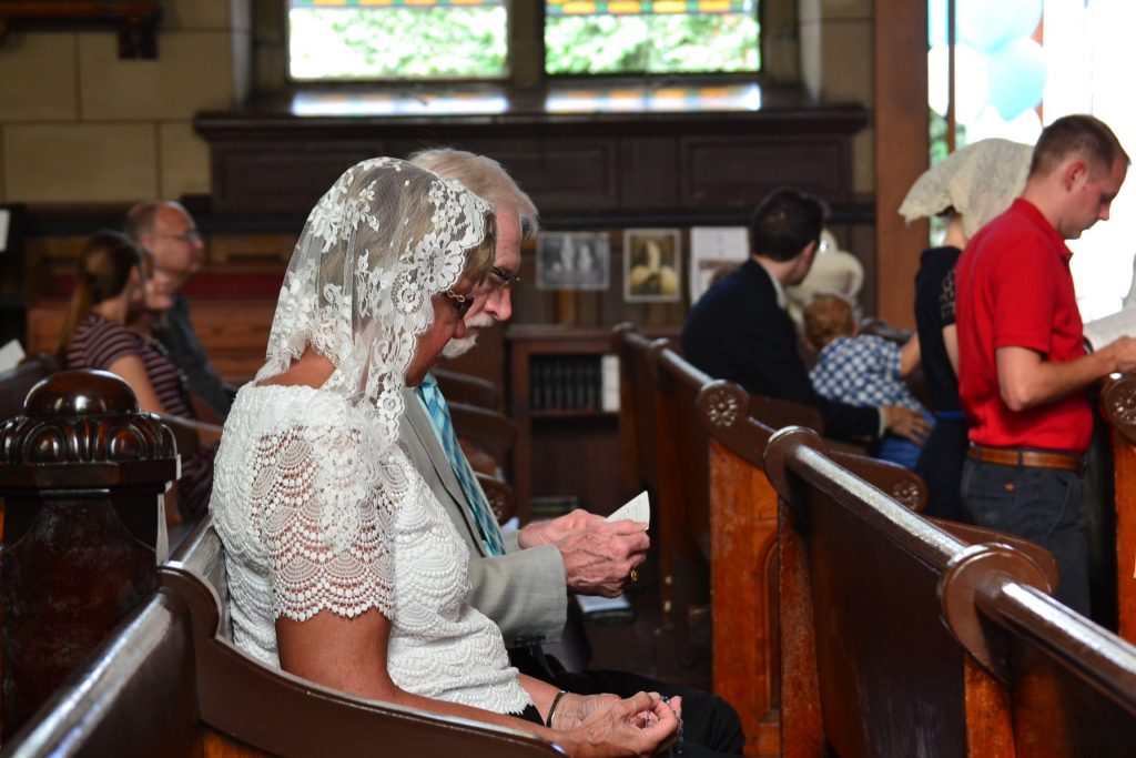 Parishioners in silent prayer before the 17th Anniversary Mass (CT Photo/Greg Hartman)