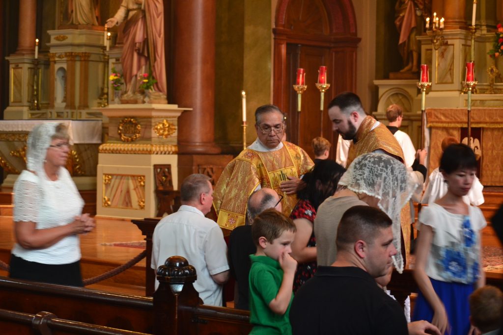 Distribution of Communion as it has for 175 years at Old St. Mary's. (CT Photo/Greg Hartman)