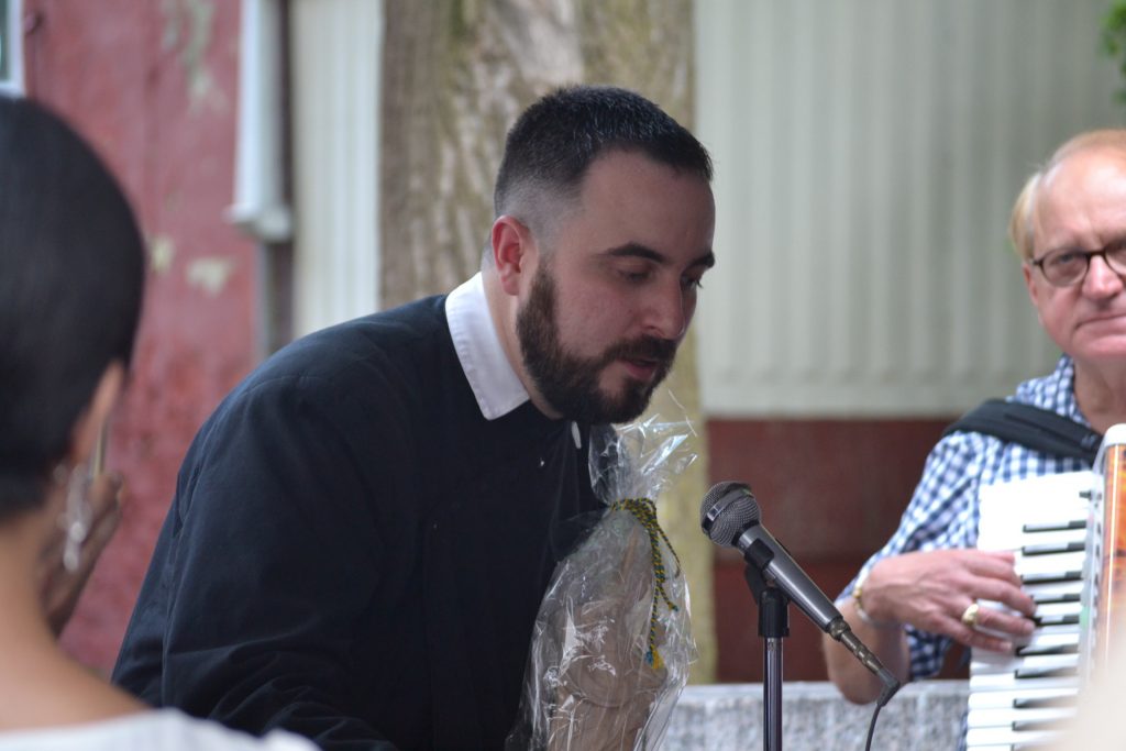 Fr. Jon-Paul Bevak accepting the statue of The Blessed Mother from Munich's St. Peter Parish. (CT Photo/Greg Hartman)